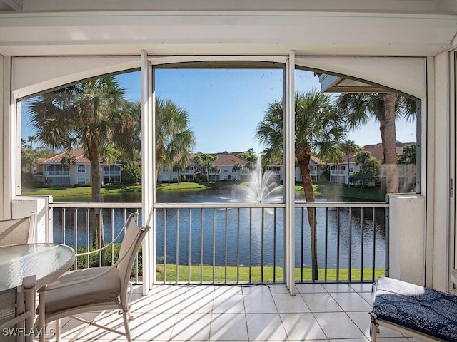 unfurnished sunroom with a water view and a wealth of natural light