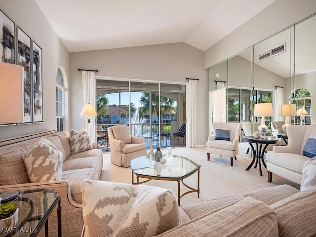 living room with light colored carpet and vaulted ceiling