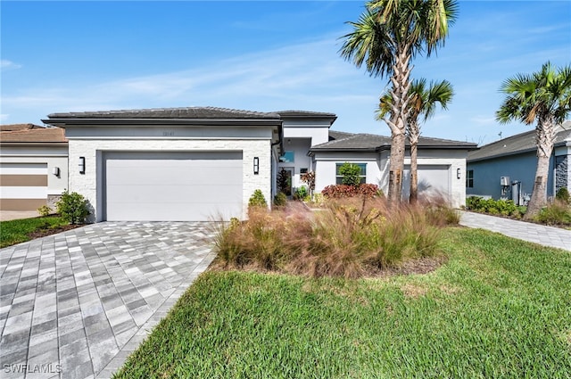 view of front of house with a front yard and a garage