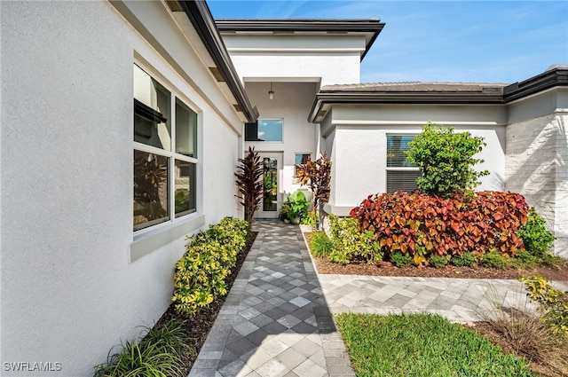 property entrance with stucco siding