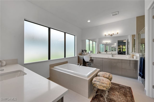 bathroom with a sink, two vanities, and a wealth of natural light