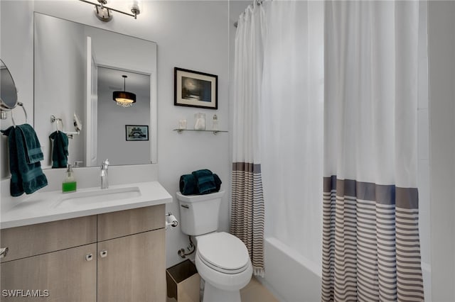 full bath featuring toilet, shower / bathtub combination with curtain, and vanity