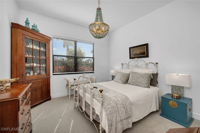 bedroom with light carpet, baseboards, and a chandelier