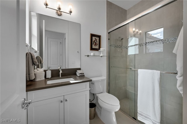 bathroom featuring a stall shower, vanity, and toilet