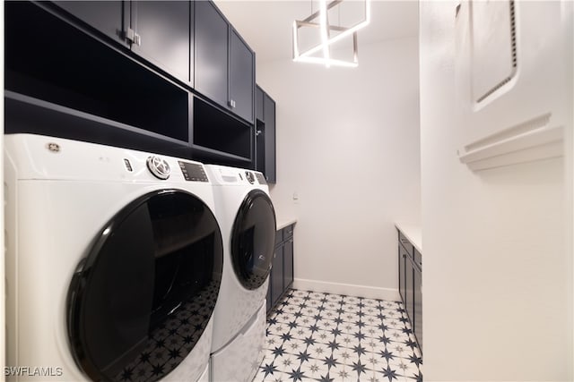 washroom featuring washer and dryer, baseboards, cabinet space, and light floors