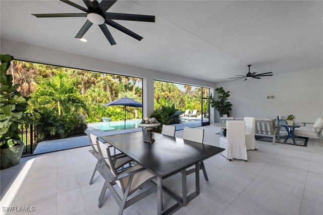 view of patio featuring an outdoor pool, a ceiling fan, and outdoor dining space