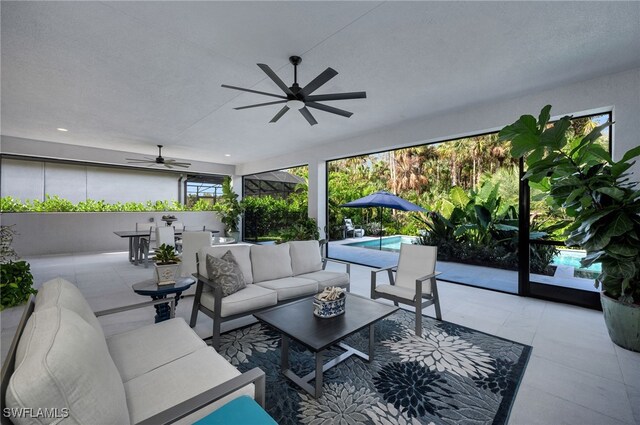 sunroom featuring a ceiling fan