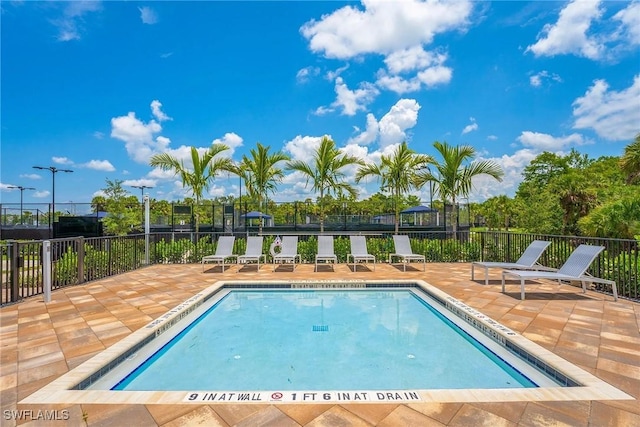 pool featuring a patio area and fence