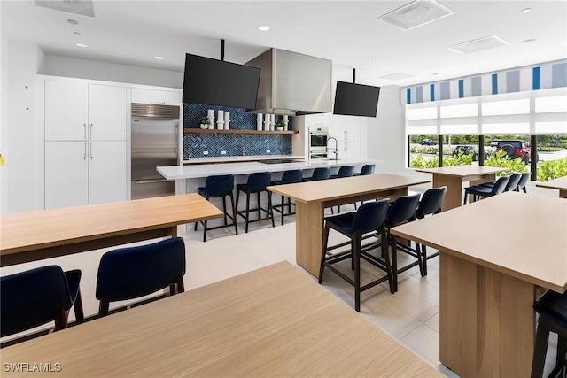 dining space with light tile patterned floors, visible vents, and recessed lighting