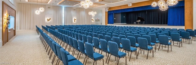 cinema room featuring coffered ceiling, carpet flooring, and an inviting chandelier