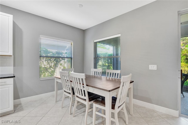 dining room featuring light tile patterned floors and a wealth of natural light