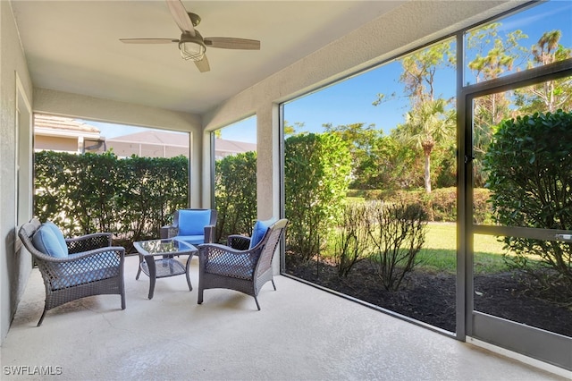 sunroom / solarium featuring ceiling fan