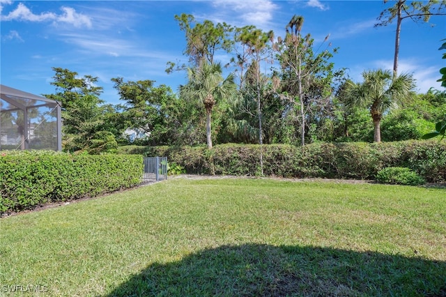 view of yard featuring glass enclosure