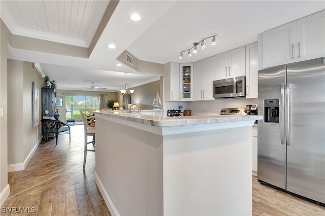 kitchen with light wood-type flooring, visible vents, appliances with stainless steel finishes, and crown molding