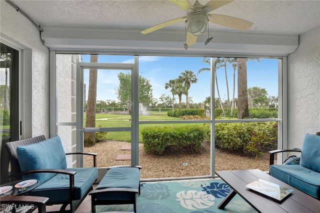 sunroom / solarium featuring a ceiling fan