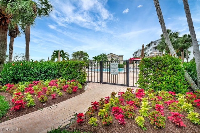 exterior space featuring fence and a community pool