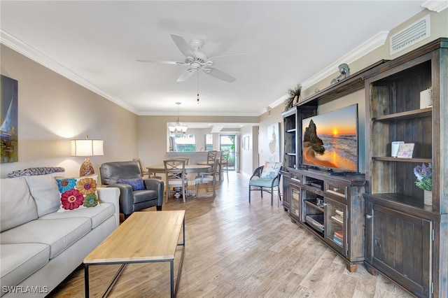 living room with crown molding, ceiling fan, and light hardwood / wood-style floors