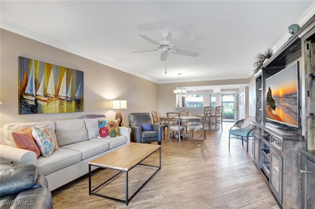 living room with crown molding, light hardwood / wood-style floors, and ceiling fan with notable chandelier