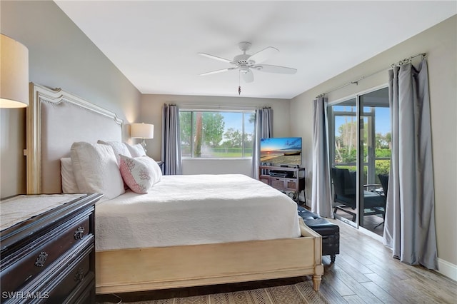 bedroom with hardwood / wood-style flooring, ceiling fan, and access to exterior