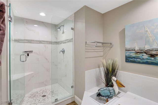 bathroom featuring a shower stall and a bath