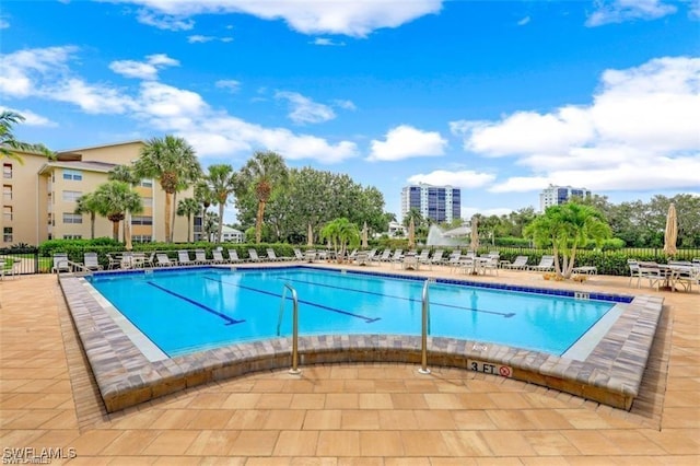 pool featuring fence and a patio