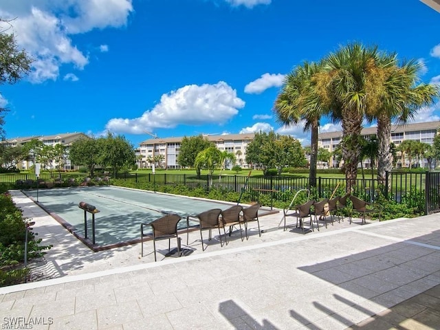 view of property's community featuring fence