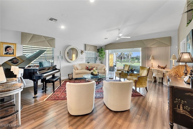 living room with ceiling fan, wood-type flooring, and lofted ceiling