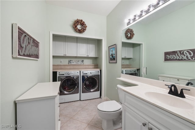 clothes washing area featuring light tile patterned floors, sink, and washing machine and clothes dryer