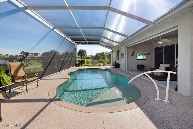 view of swimming pool featuring a lanai, ceiling fan, and a patio