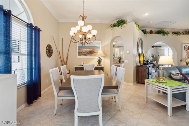 dining area featuring ceiling fan with notable chandelier, light tile patterned floors, and crown molding