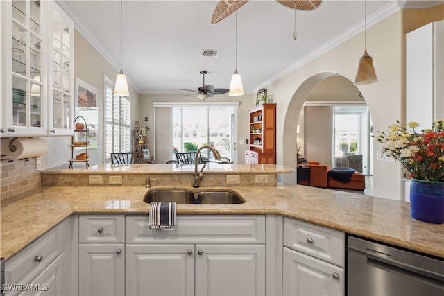 kitchen with light stone counters, ceiling fan, sink, dishwasher, and white cabinets