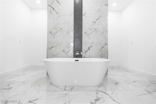 bathroom with tile walls and a bathing tub