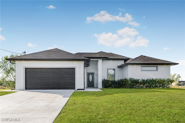 prairie-style home featuring a front lawn and a garage