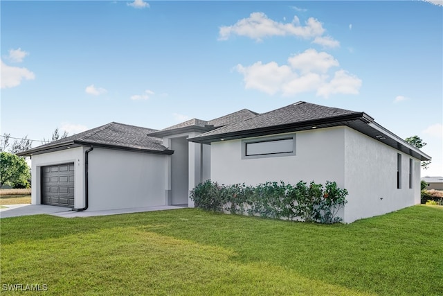 view of front of property with a front yard and a garage