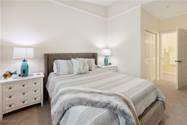 carpeted bedroom with connected bathroom, ornamental molding, and a closet