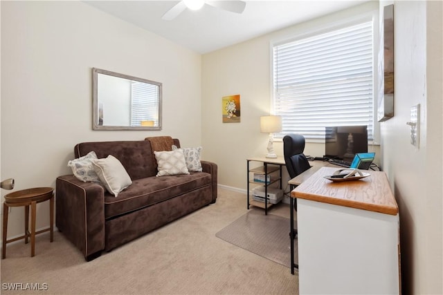 carpeted home office featuring ceiling fan