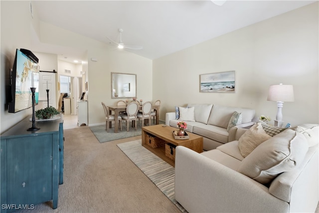 living room featuring ceiling fan, light carpet, and lofted ceiling