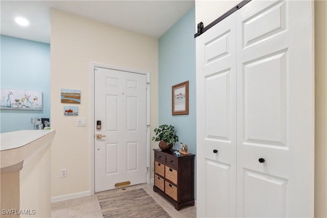 tiled entrance foyer with a barn door