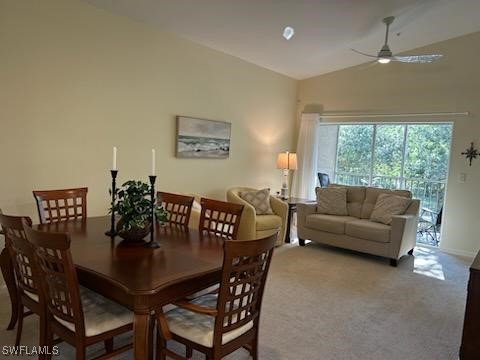 dining room featuring ceiling fan, carpet, and high vaulted ceiling