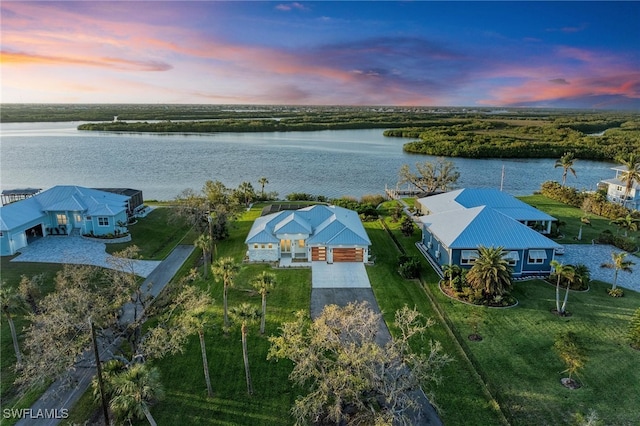 aerial view at dusk with a water view