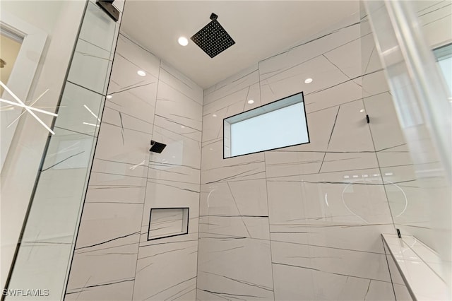 bathroom with a tile shower