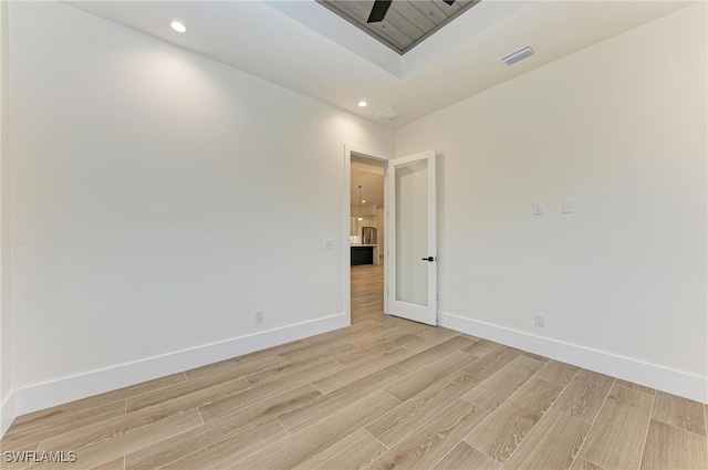 unfurnished room with ceiling fan and light hardwood / wood-style floors