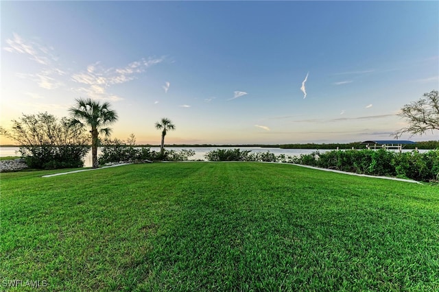 yard at dusk with a water view