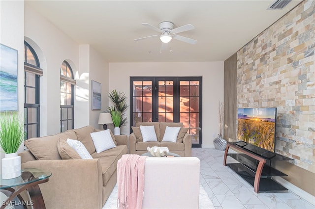 living room featuring french doors and ceiling fan