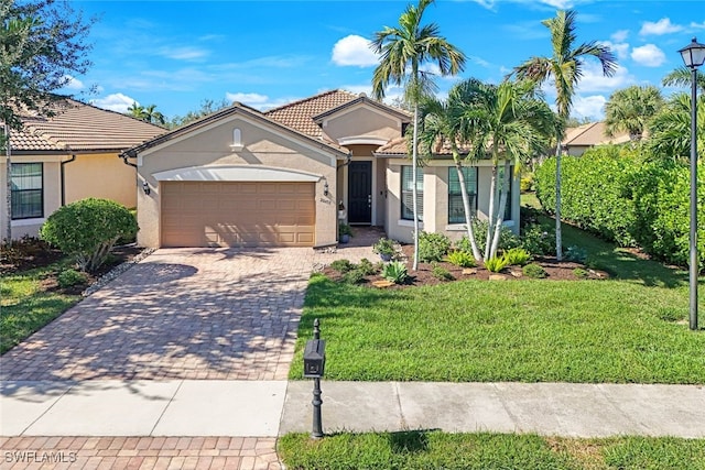 view of front of home featuring a front yard and a garage