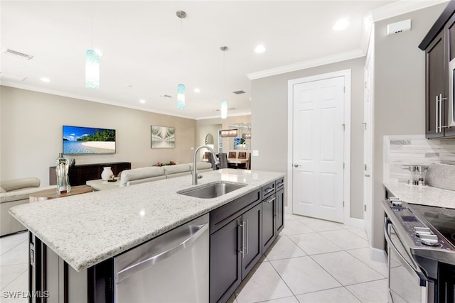 kitchen with sink, hanging light fixtures, an island with sink, tasteful backsplash, and stainless steel appliances