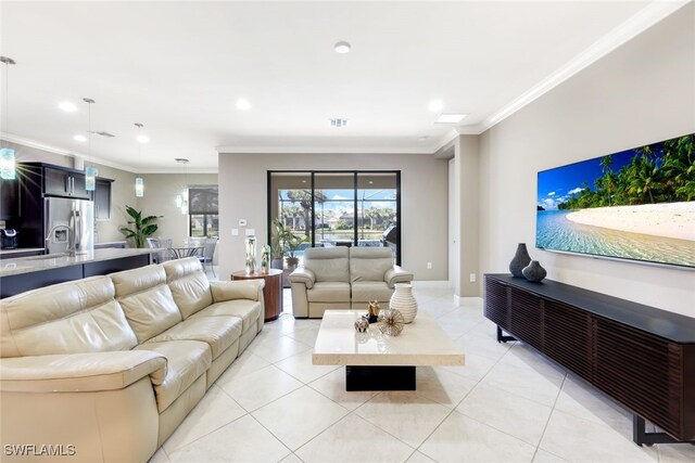 living room with ornamental molding and light tile patterned floors