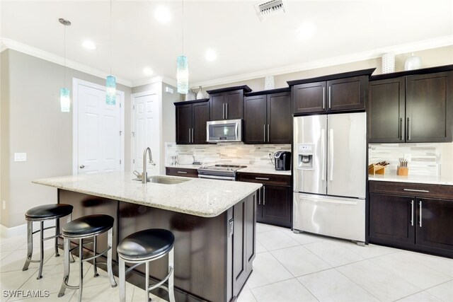 kitchen with a center island with sink, sink, and appliances with stainless steel finishes