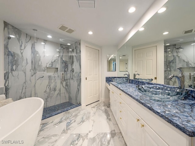 bathroom featuring shower with separate bathtub, vanity, and tile walls