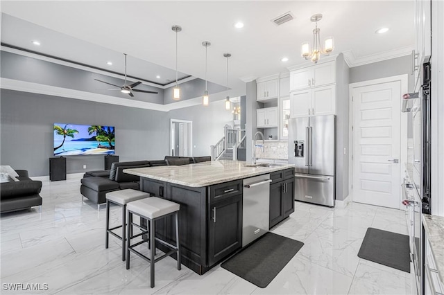 2038 Bahama Ave, Fort Myers, FL 33905 - kitchen with appliances with stainless steel finishes, a sink, ornamental molding, open floor plan, and light marble finish floors
